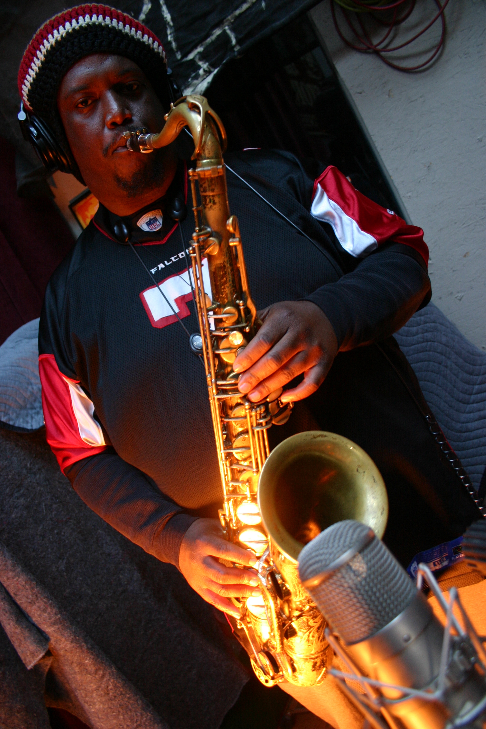 Kamasi Washington playing a saxophone with the band "Throttle Elevator Music."