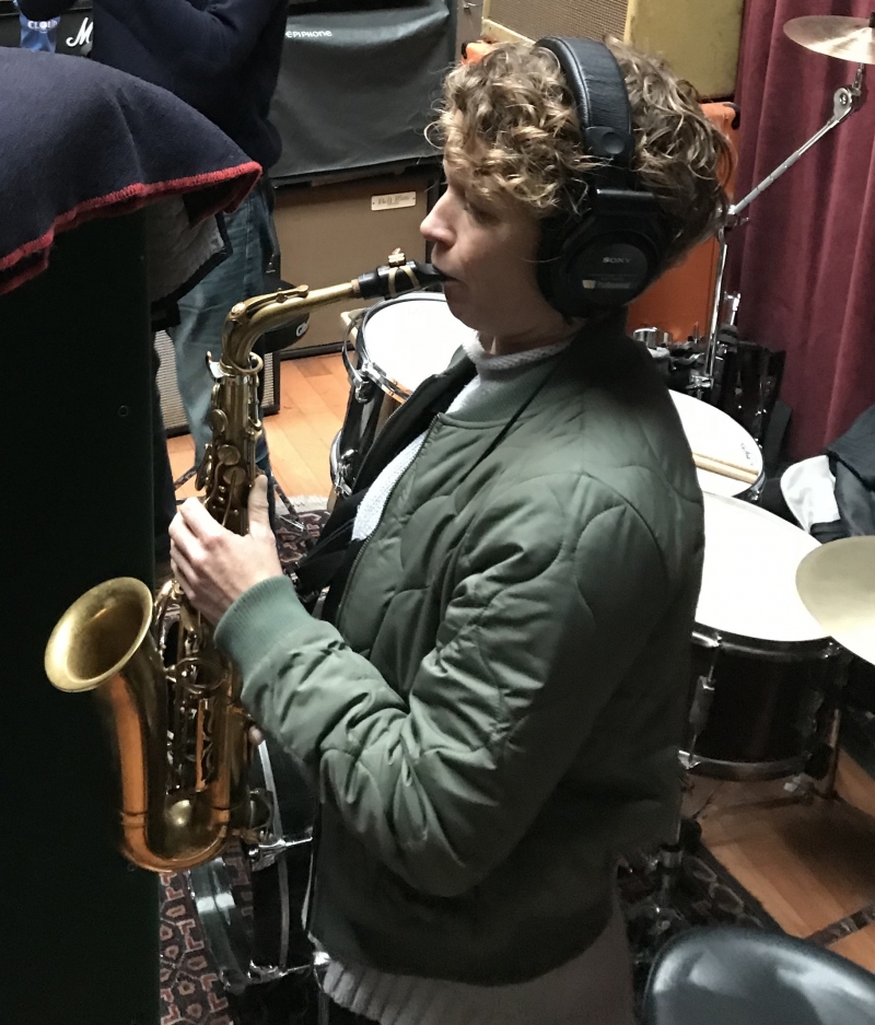 A photo of Kasey Knudsen playing the saxophone at Wide Hive Records in Berkeley, California.