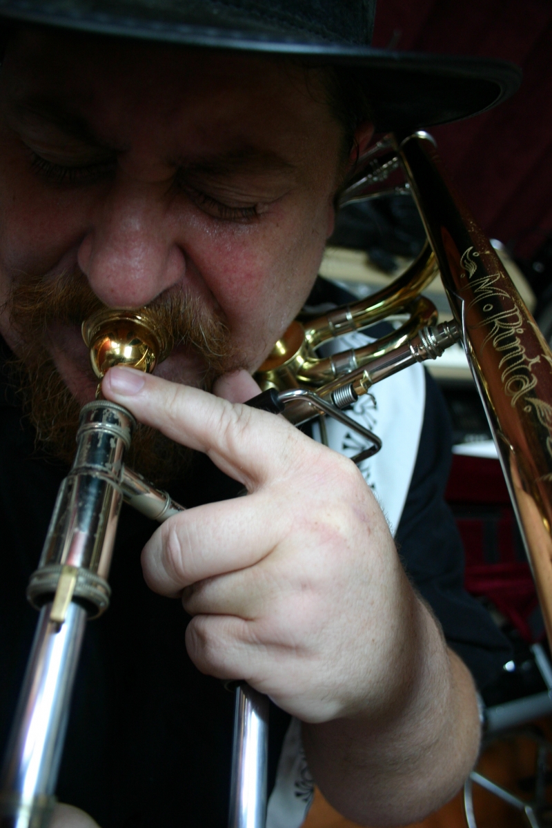 A picture of Mike Rinta playing the trombone.