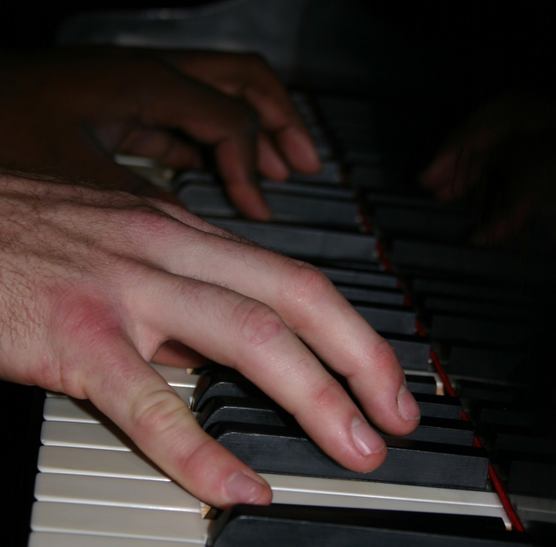 A photo of the Wide Hive Players at the piano.