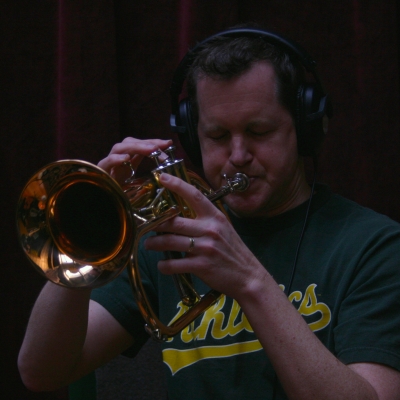 A picture of Erik Jekabson playing a trumpet.