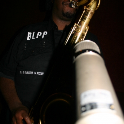 Kamasi Washington, playing a saxophone on the Throttle Elevator Music album "Area J."