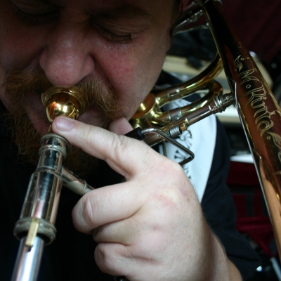 A picture of Mike Rinta playing the trombone.