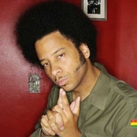 A photo of Boots Riley looking thoughtful.
