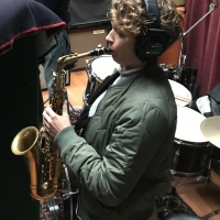 A photo of Kasey Knudsen playing the saxophone at Wide Hive Records in Berkeley, California.